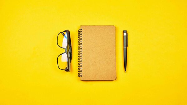 A notebook and pen on a table with a calm, minimal look